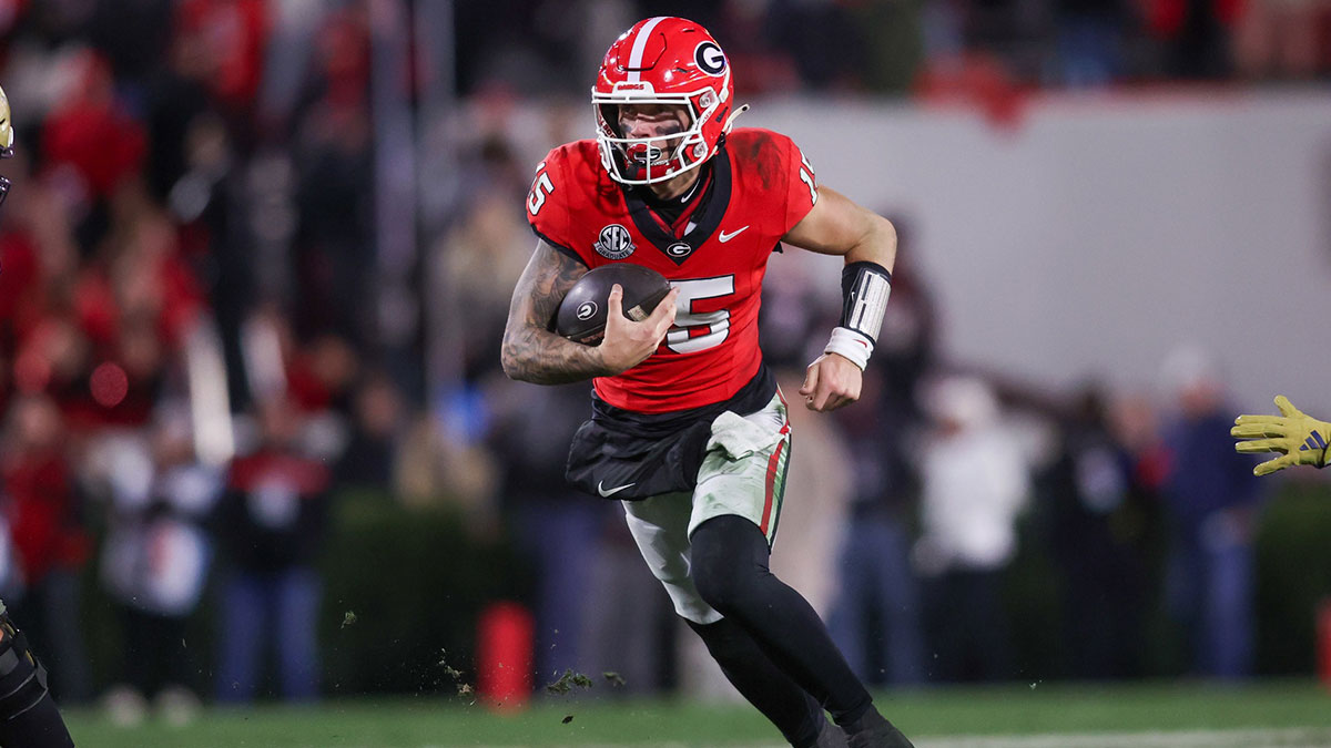 Georgia Bulldogs quarterback Carson Beck (15) runs the ball against the Georgia Tech Yellow Jackets in the fourth quarter at Sanford Stadium.