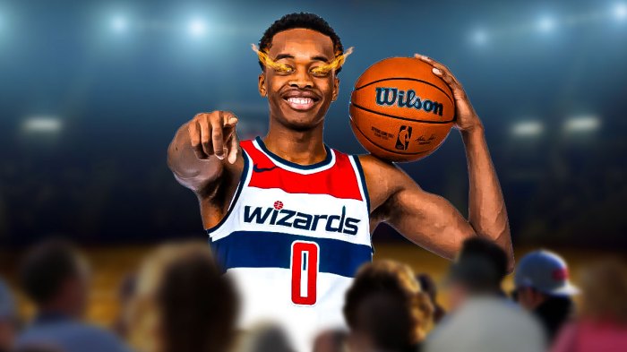 Bilal Coulibaly smiles and holds basketball with fire in his eyes