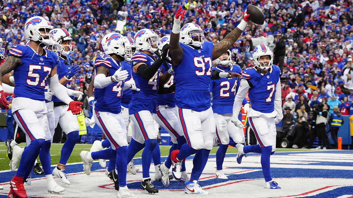 Buffalo Bills defensive tackle Zion Logue (97) celebrates intercepting a pass with teammates during the first half against the New York Jets at Highmark Stadium.