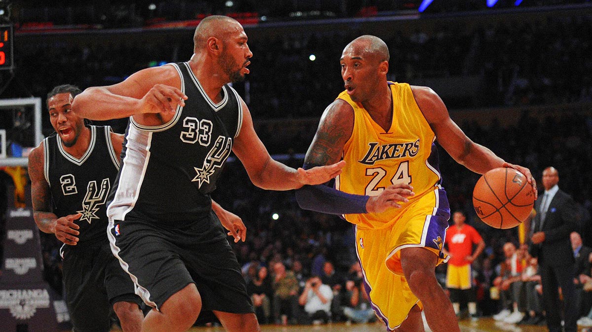 Los Angeles Lakers forward Kobe Bryant (24) moves the ball against San Antonio Spurs center Boris Diaw (33) during the first half at Staples Center.