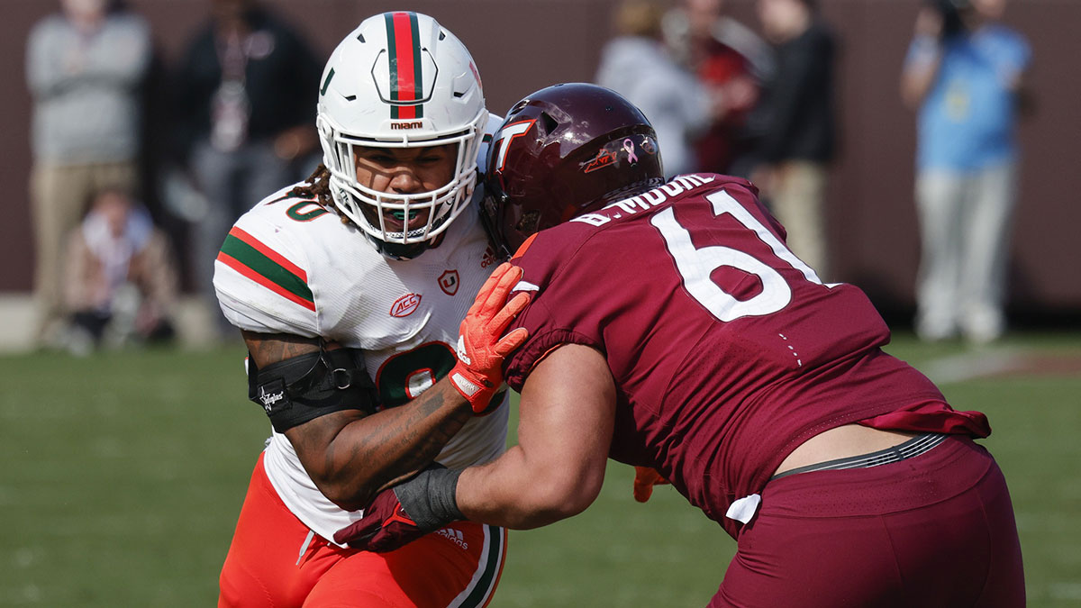 Virginia Tech Hokies offensive lineman Braelin Moore (61) blocks Miami Hurricanes defensive lineman Akheem Mesidor (90) during the second half at Lane Stadium.