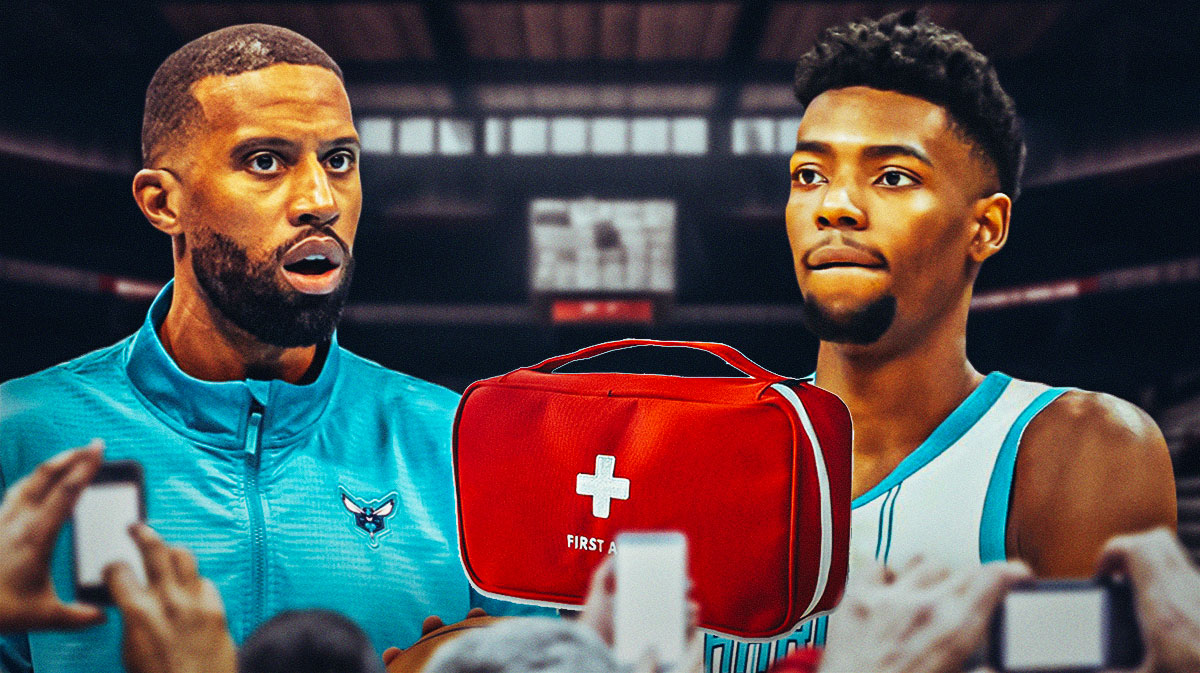 Hornets Charles Lee next to Brandon Miller with a first aid kit in front of Miller.