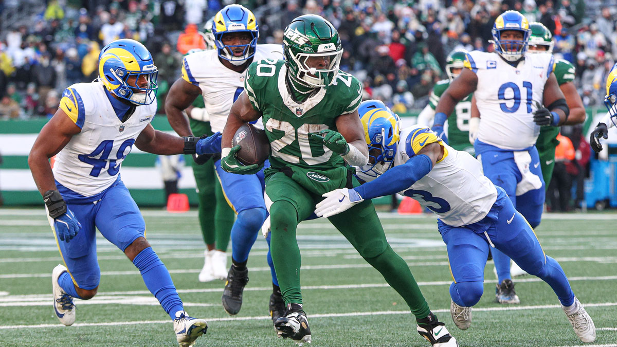 New York Jets running back Breece Hall (20) carries the ball as Los Angeles Rams safety Kamren Curl (3) tackles during the second half at MetLife Stadium.