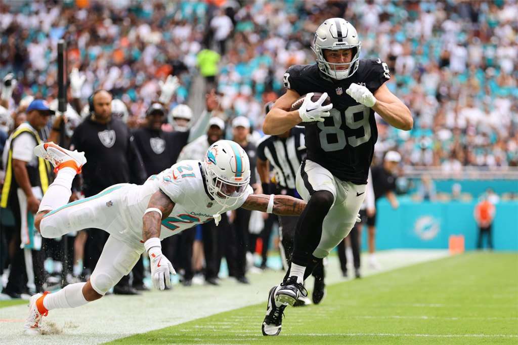 Las Vegas Raiders tight end Brock Bowers (89) runs with the football past Miami Dolphins safety Jordan Poyer (21) during the third quarter at Hard Rock Stadium.