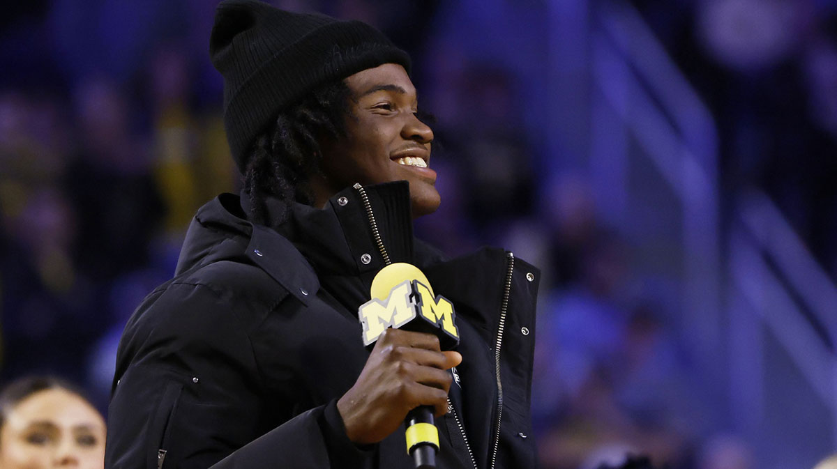 Michigan Wolverines quarterback commit Bryce Underwood addresses the crowd during a basketball game against the Iowa Hawkeyes at Crisler Center.