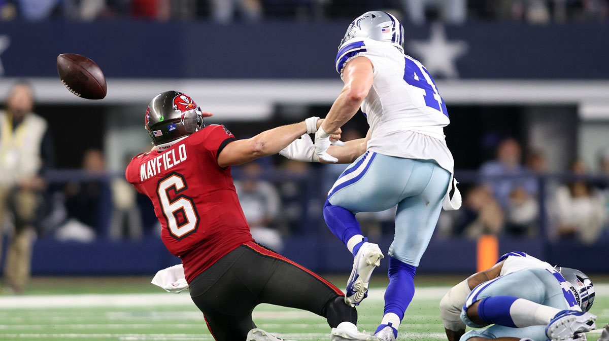 Tampa Bay Buccaneers quarterback Baker Mayfield (6) fumbles the ball after being hit by Dallas Cowboys linebacker Nick Vigil (41) in the second half at AT&T Stadium. 