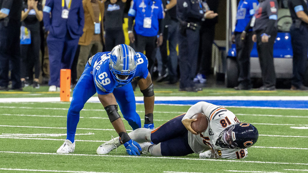 Detroit Lions linebacker Al-Quadin Muhammad (69) sacks Chicago Bears quarterback Caleb Williams (18) during the second half at Ford Field.