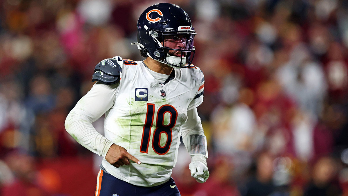 Chicago Bears quarterback Caleb Williams (18) celebrates after the Bears scored a touchdown during the fourth quarter against the Washington Commanders at Commanders Field.