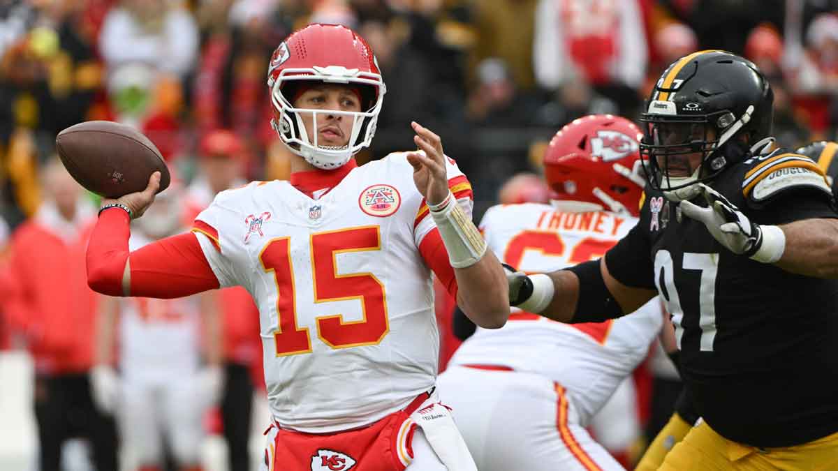 Dec 25, 2024; Pittsburgh, Pennsylvania, USA; Kansas City Chiefs quarterback Patrick Mahomes (15) throws a pass while being pressured by Pittsburgh Steelers defensive tackle Cameron Heyward (97) during the first quarter at Acrisure Stadium. 