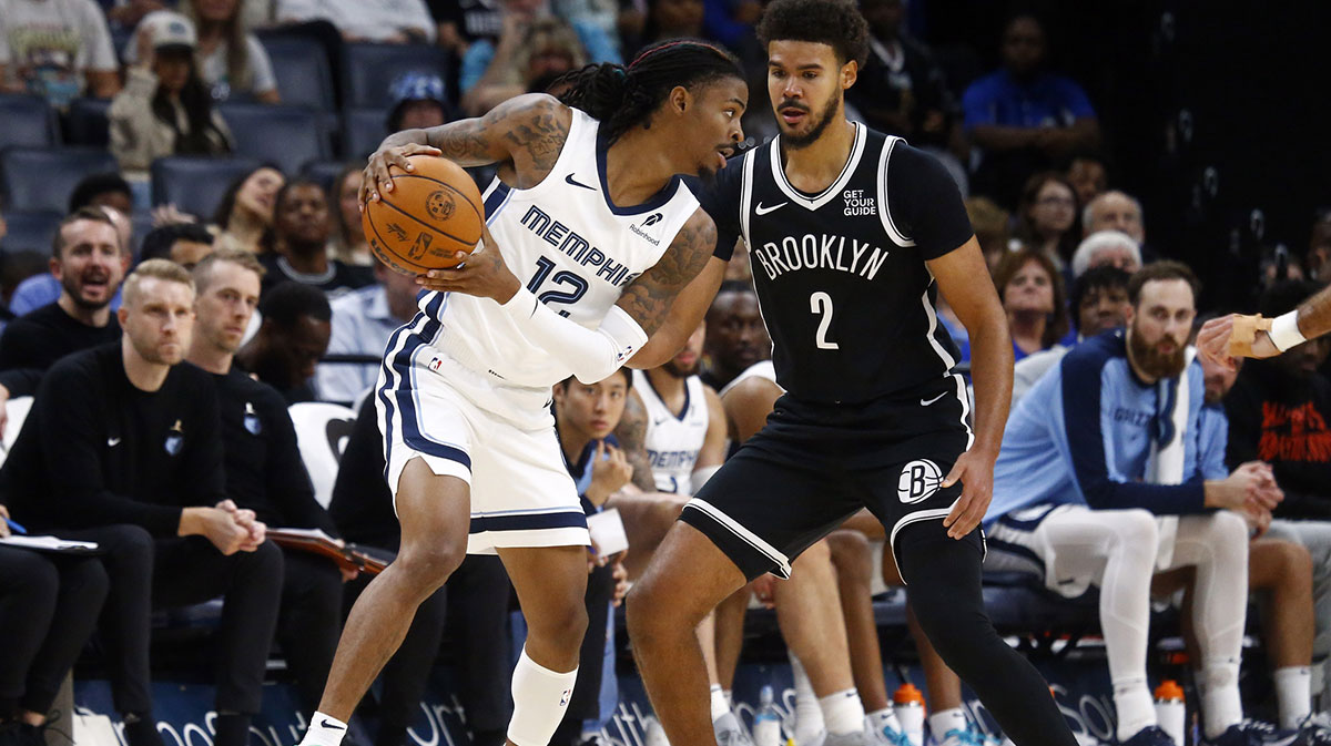 Memphis Grizzlies guard Ja Morant (12) handles the ball as Brooklyn Nets forward Cameron Johnson (2) defends during the first half at FedExForum.