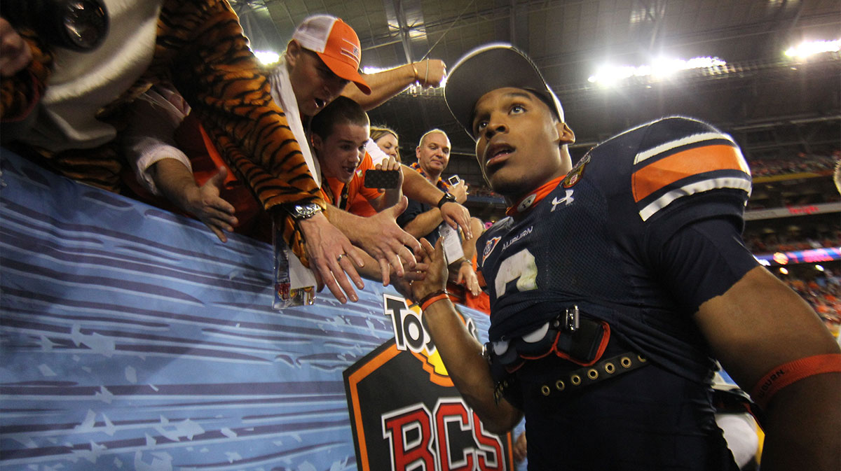 Auburn Tigers quarterback Cam Newton (2) celebrates with fans after the 2011 BCS National Championship game against the Oregon Ducks at University of Phoenix Stadium. The Tigers defeated the Ducks 22-19.