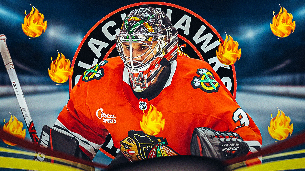 Petr Mrazek in image looking happy with fire around him, Chicago Blackhawks logo, hockey rink in background