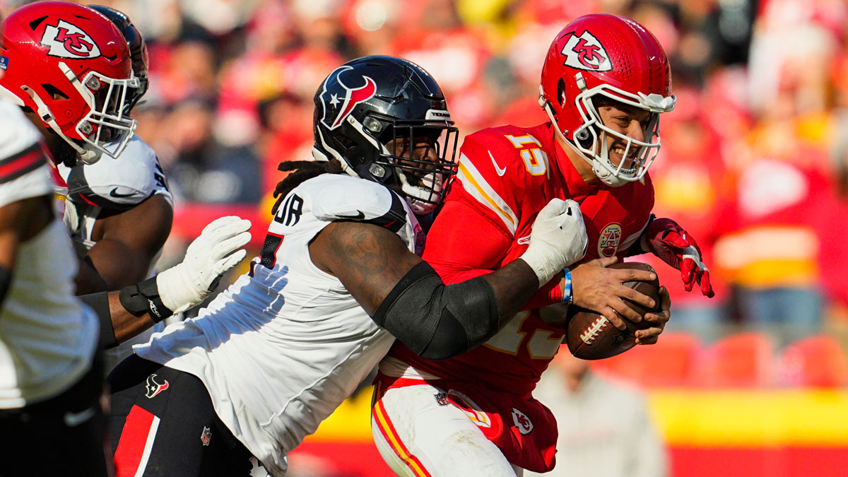 Chiefs quarterback Patrick Mahomes (15) is tackled by Houston Texans defensive tackle Mario Edwards Jr. (97) during the first half at GEHA Field at Arrowhead Stadium