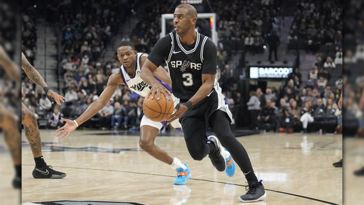 San Antonio Spurs Guard Chris Paul (3) passes the ball while defending Sacramento Kings Guard De'aaron Fox (5) during the first half in the Bank Bank Centura.