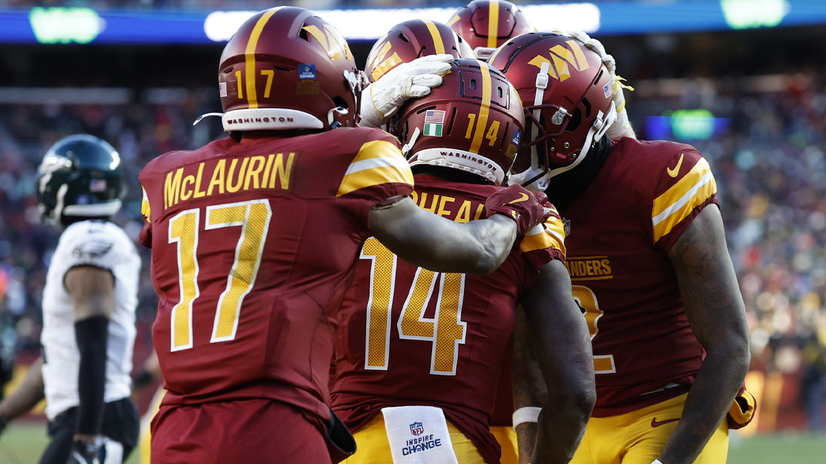 Washington Commanders wide receiver Olamide Zaccheaus (14) celebrates with teammates after scoring a touchdown against the Philadelphia Eagles during the fourth quarter at Northwest Stadium.