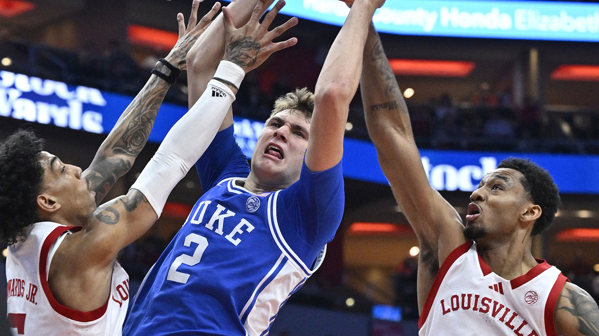 Duke Blue Devils guard Cooper Flagg (2) shoots against Louisville Cardinals guard Terrence Edwards Jr. (5) and forward James Scott (0) during the first half at KFC Yum! Center.