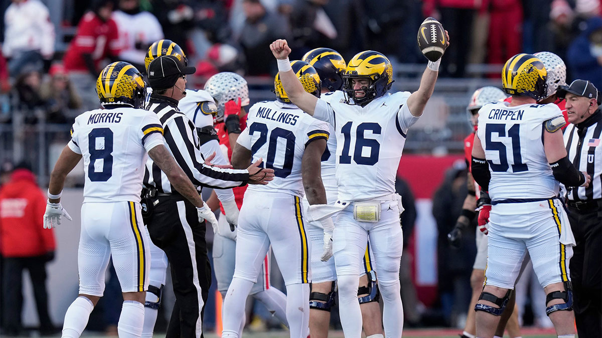 Michigan Wolverines quarterback Davis Warren (16) celebrates a 13-10 win over Ohio State Buckeyes at the end of the NCAA football game at Ohio Stadium in Columbus on Saturday, Nov. 30, 2024.