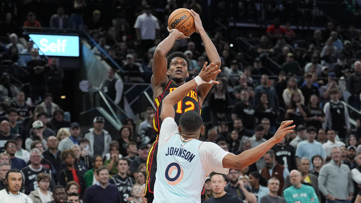 Atlanta Hawks forward De'Andre Hunter (12) shoots over San Antonio Spurs forward Keldon Johnson (0) in overtime at Frost Bank Center.