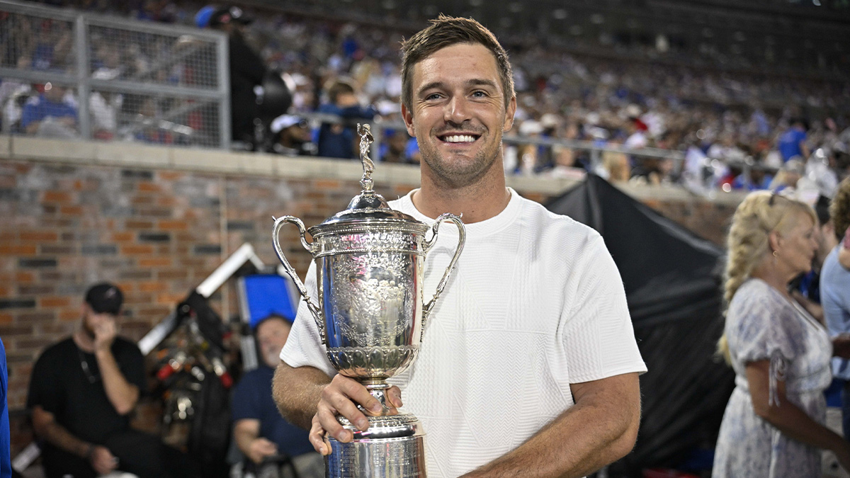 Professional golfer Bryson DeChambeau poses with the US Open trophy on the sidelines during the game between the Southern Methodist Mustangs and the Pittsburgh Panthers at Gerald J. Ford Stadium.
