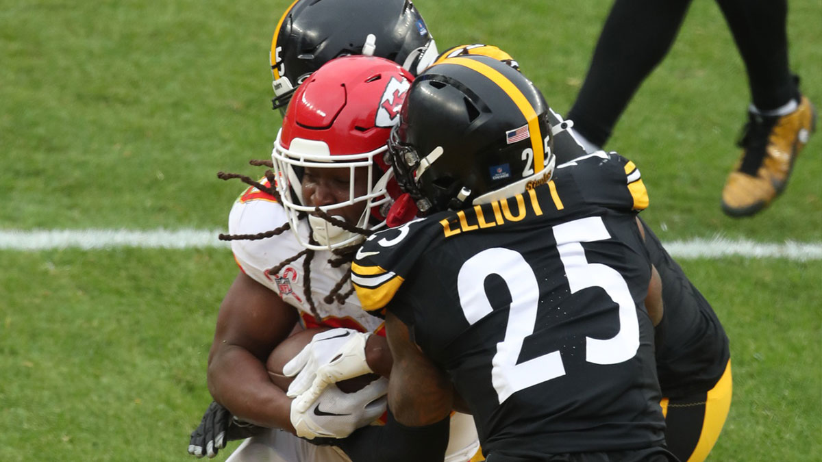 Kansas City Chiefs running back Kareem Hunt (29) scores a touchdown as Pittsburgh Steelers defensive tackle Keeanu Benton (rear) and safety DeShon Elliott (25) defend during the fourth quarter at Acrisure Stadium. 