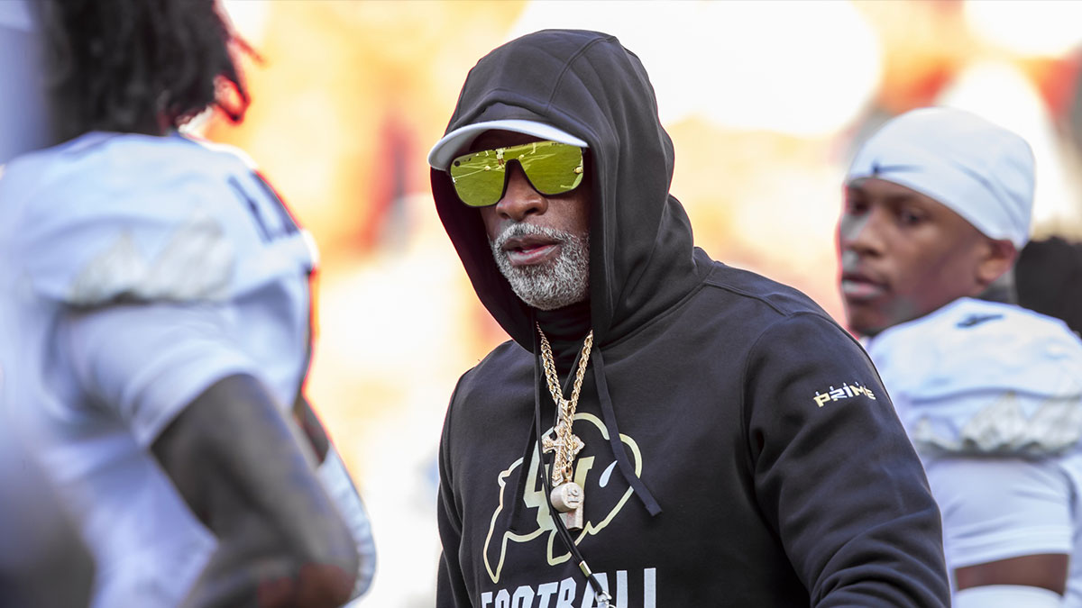 Colorado head coach Deion Sanders watches his players warmup prior to the game between the Kansas Jayhawks and the Colorado Buffaloes at GEHA Field at Arrowhead Stadium.