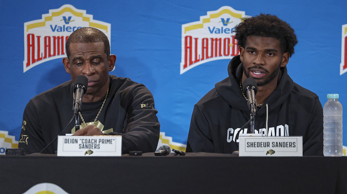 Colorado Buffaloes head coach Deion Sanders and quarterback Shedeur Sanders (2) talk with the media after the game against the Brigham Young Cougars at Alamodome