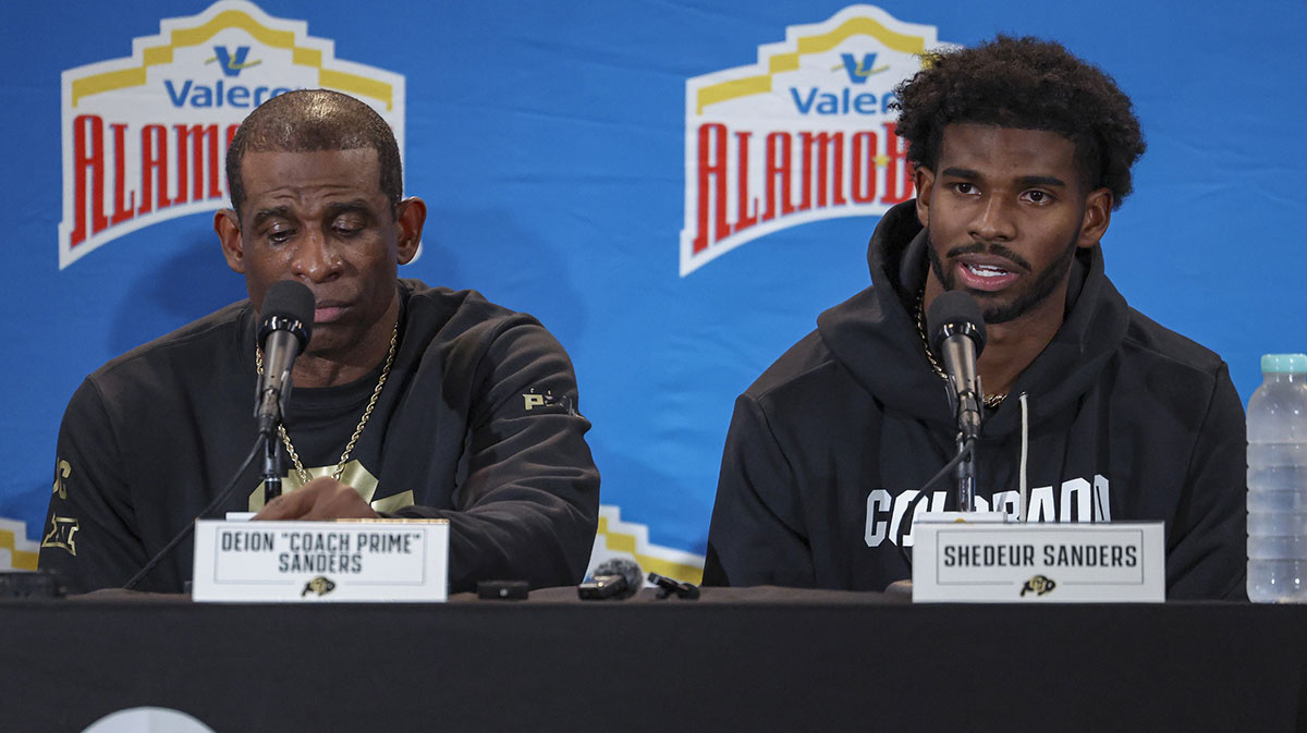 Colorado Buffaloes head coach Deion Sanders and quarterback Shedeur Sanders (2) talk with the media after the game against the Brigham Young Cougars at Alamodome.