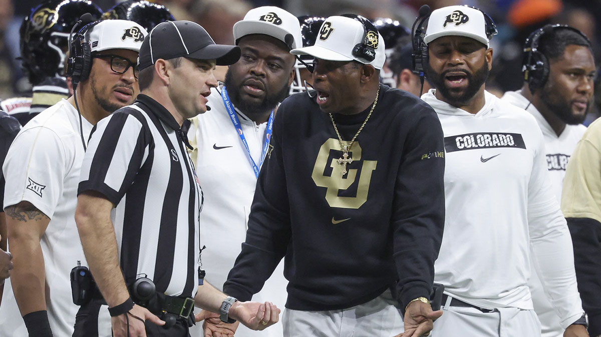 Colorado Buffaloes head coach Deion Sanders reacts with an official after a play during the second quarter against the Brigham Young Cougars at Alamodome.