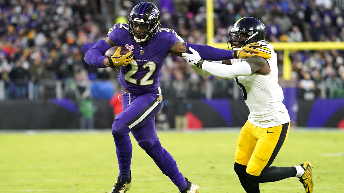 Dec 21, 2024; Baltimore, Maryland, USA; Baltimore Ravens running back Derrick Henry (22) runs for a gain defended by Pittsburgh Steelers linebacker Patrick Queen (6) in the first quarter at M&T Bank Stadium. Mandatory Credit: Mitch Stringer-Imagn Images