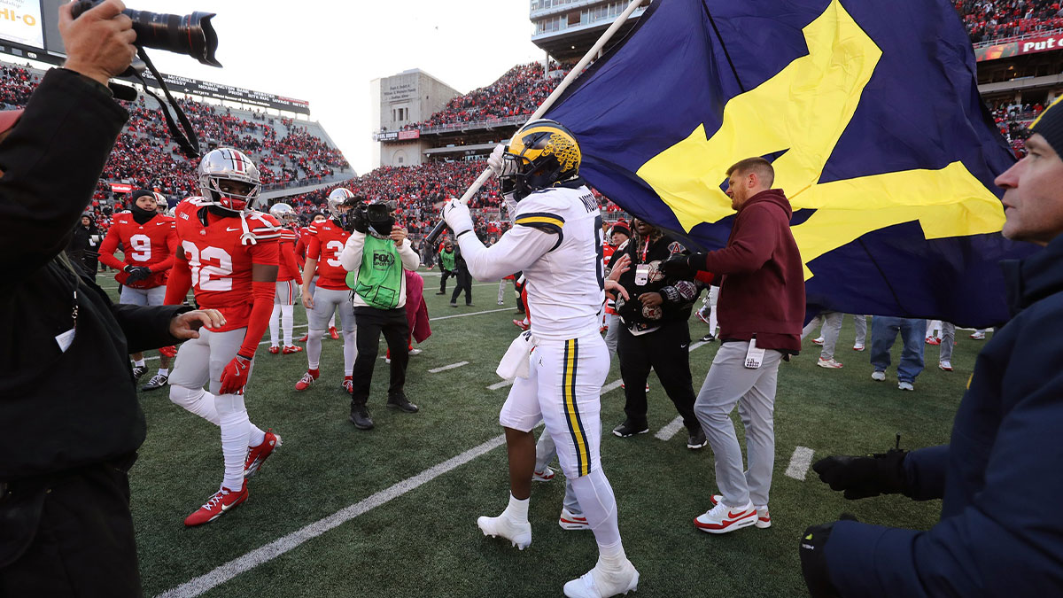 Michigan Wolverines defensive end Derrick Moore (8) attempts to plant the flag on the Ohio State Buckeyes logo as Ohio State Buckeyes defensive end Jack Sawyer (33) rips the flag down after the game at Ohio Stadium.