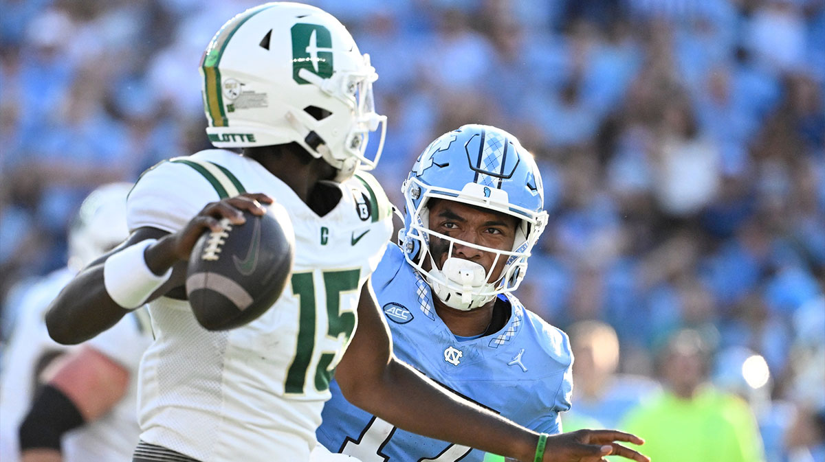 Charlotte 49ers quarterback Deshawn Purdie (15) looks to pass as DUPLICATE***North Carolina Tar Heels linebacker Amare Campbell (17)***North Carolina Tar Heels quarterback Michael Merdinger (17) pressures in the third quarter at Kenan Memorial Stadium.