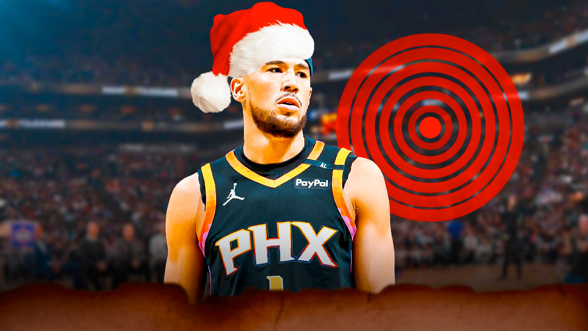 Devin Booker (Suns) with a Santa hat and a PAIN SYMBOL in the background