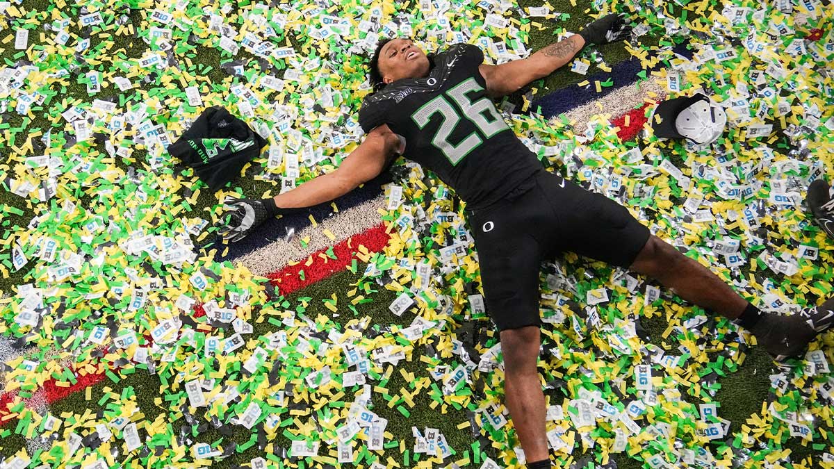 Oregon Ducks linebacker Devon Jackson (26) makes a confetti angel on Sunday, Dec. 8, 2024, after the Big Ten Championship game at Lucas Oil Stadium in Indianapolis. The Oregon Ducks defeated the Penn State Nittany Lions, 45-37.