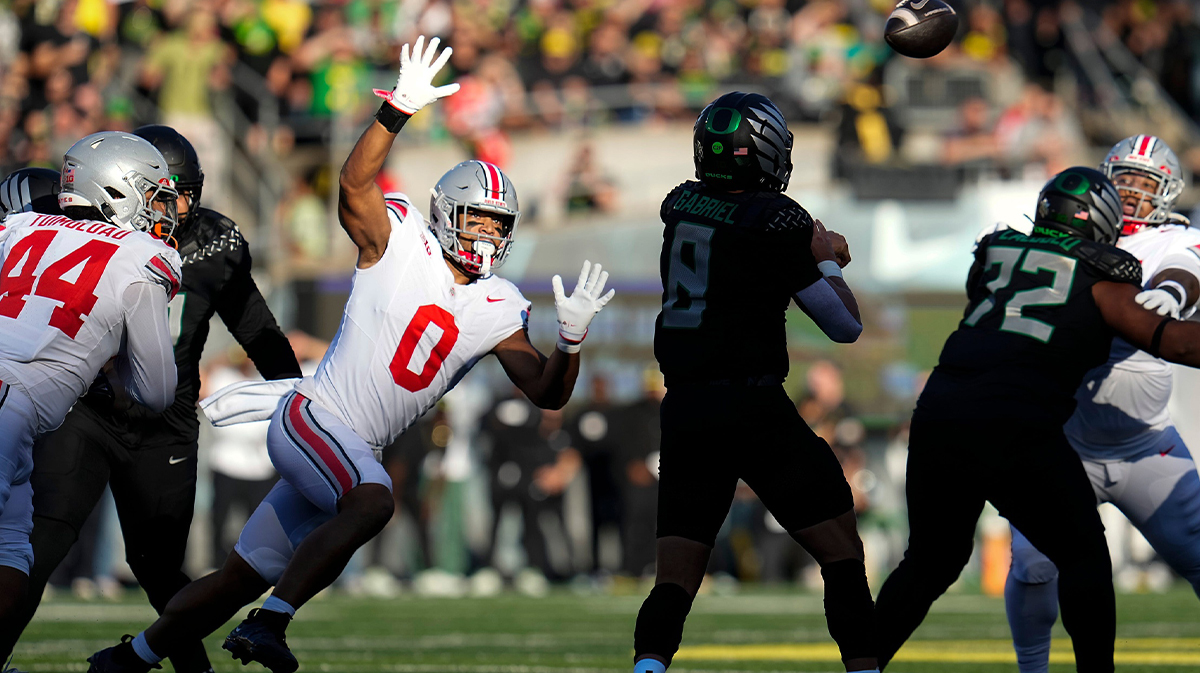 Oct 12, 2024; Eugene, Oregon, USA; Ohio State Buckeyes linebacker Cody Simon (0) pressures Oregon Ducks quarterback Dillon Gabriel (8) during the first half of the NCAA football game at Autzen Stadium