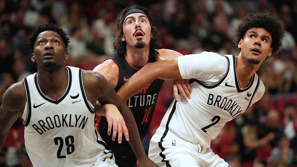 Miami Heat guard Jaime Jaquez Jr. (11) battles for position with Brooklyn Nets forward Dorian Finney-Smith (28) and forward Cameron Johnson (2) in the first half at Kaseya Center.