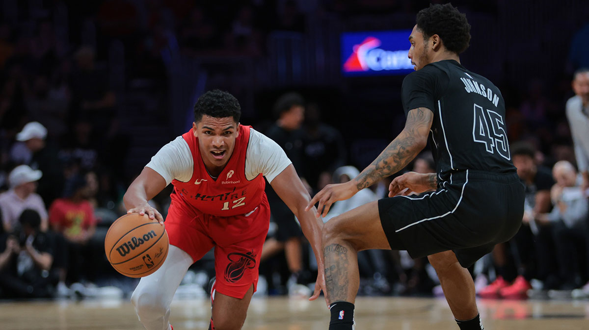 Miami Heat guard Dru Smith (12) slides while dribbling the basketball against Brooklyn Nets guard Keon Johnson (45) during the second quarter at Kaseya Center.