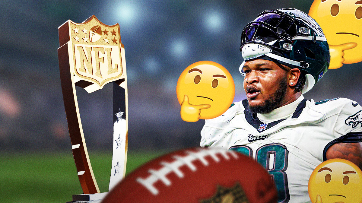 Eagles' Jalen Carter standing next to the Defensive Player of the Year award with these emojis (🤔) surrounding him and question marks too