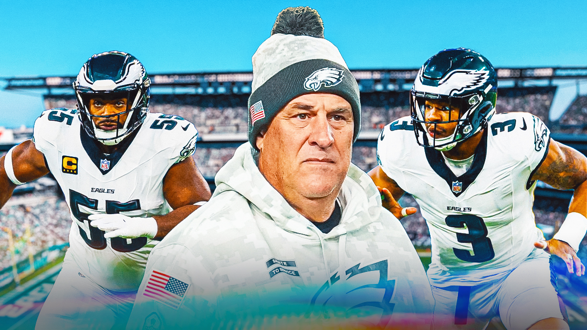 Vin Fangio next to Brandon Graham and Nolan Smith in front of the Eagles stadium