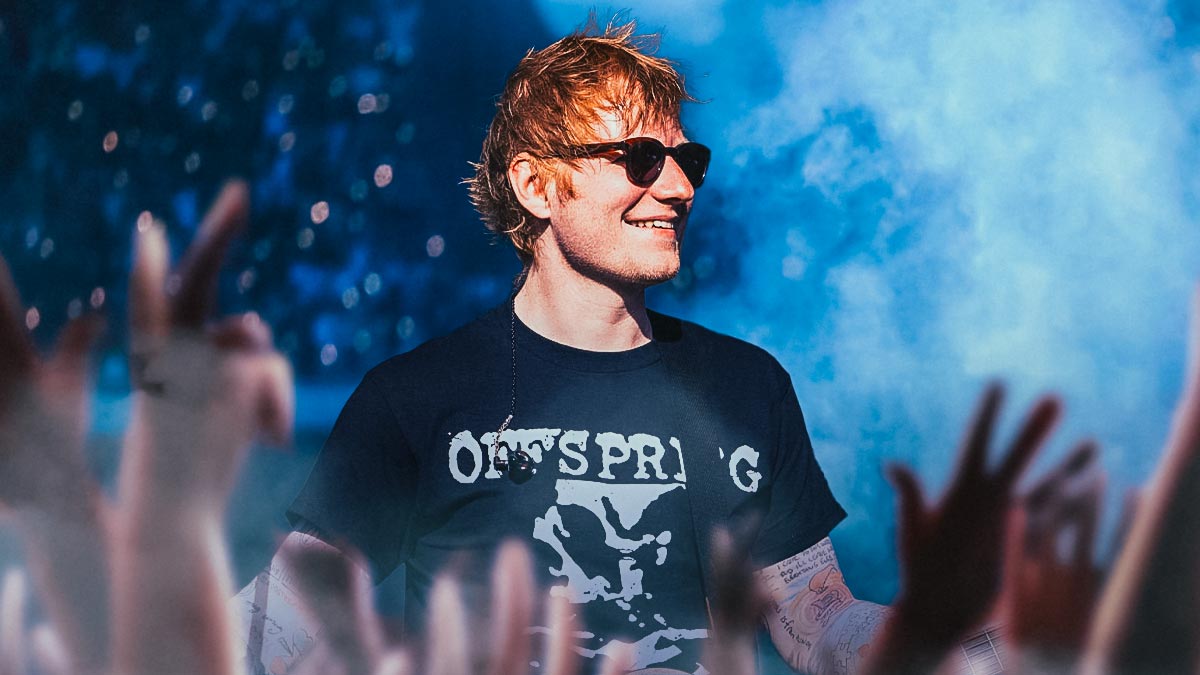 Ed Sheeran, who will be on tour in 2025 and perform in the UK, with Wembley Stadium crowd background.