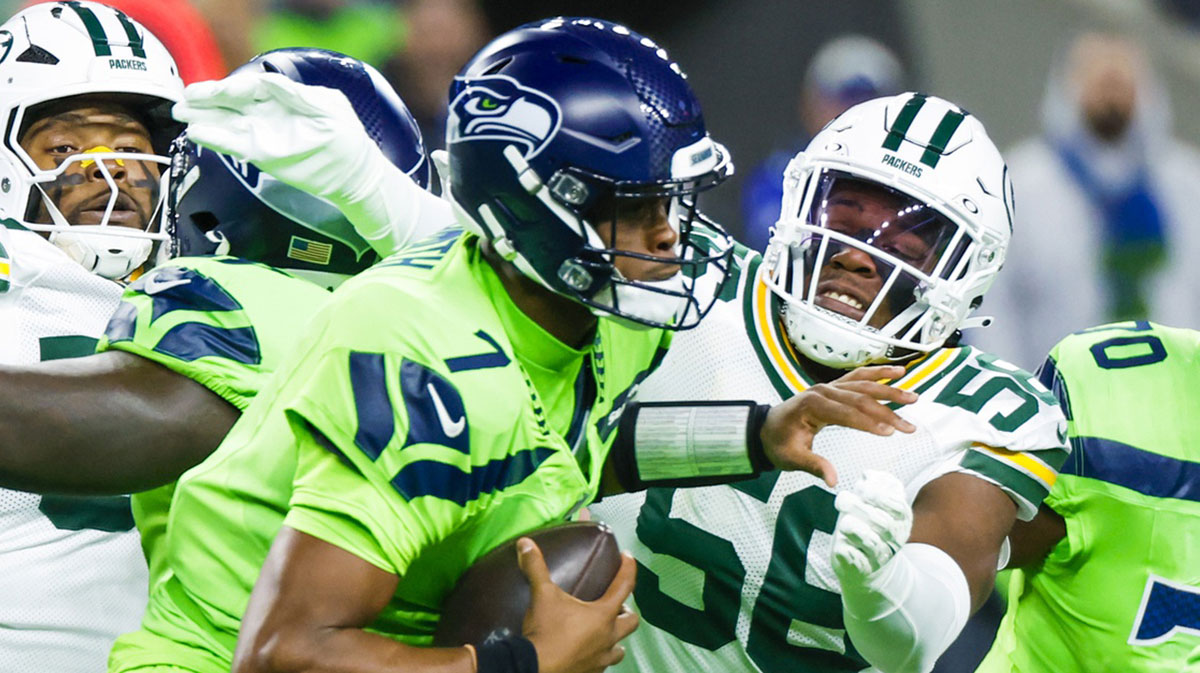 Green Bay Packers linebacker Edgerrin Cooper (56) sacks Seattle Seahawks quarterback Geno Smith (7) during the first quarter at Lumen Field.