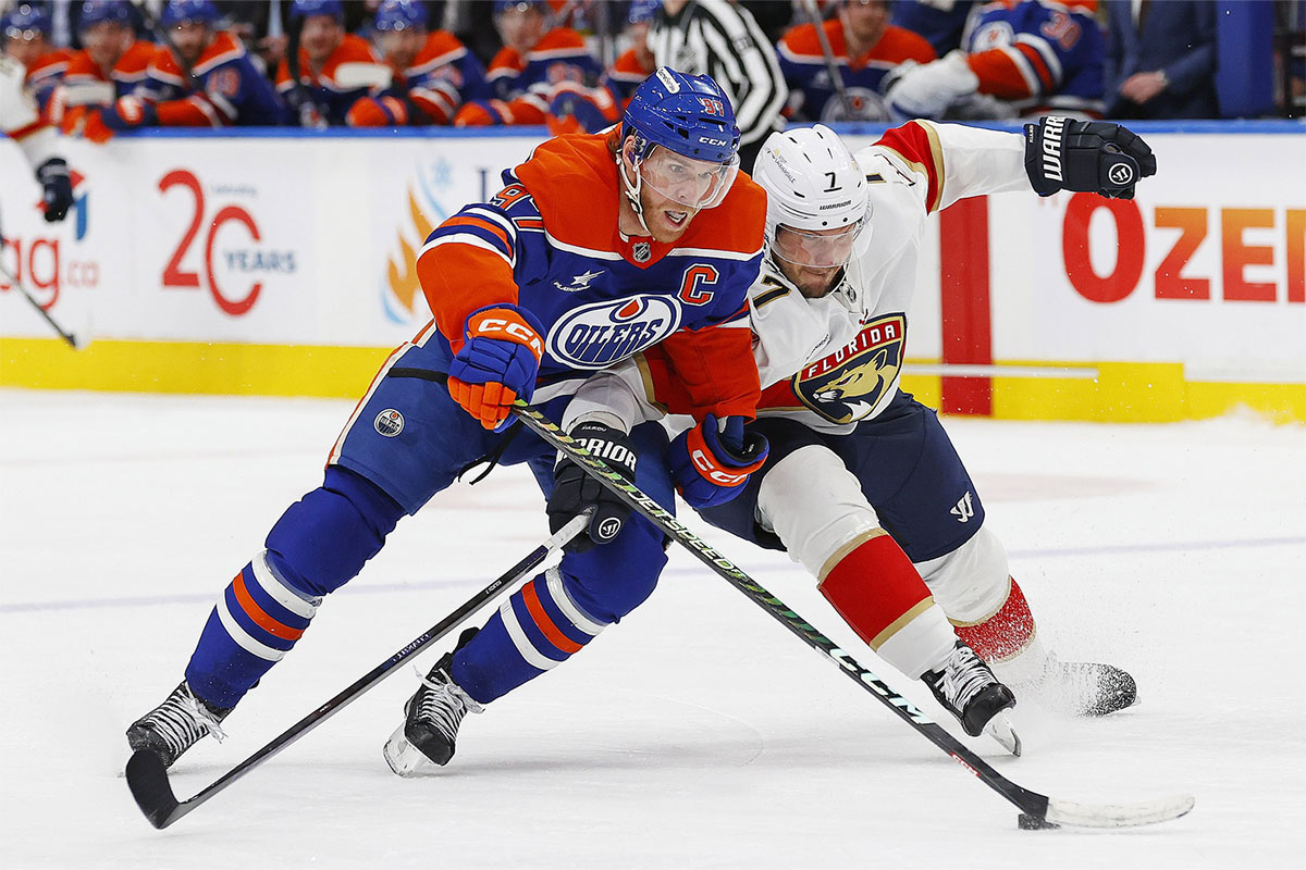 Florida Panthers defensemen Dmitry Kulikov (7) tries to tie up Edmonton Oilers forward Connor McDavid (97) during the third period at Rogers Place.