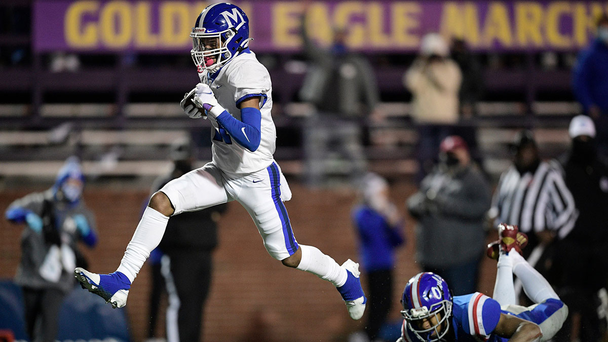 McCallie's Eric Rivers (11) goes in for a touchdown as MUS Tylyn Young (3) defends during the second quarter of the Division II-AAA BlueCross Bowl Football Championship game at Tucker Stadium