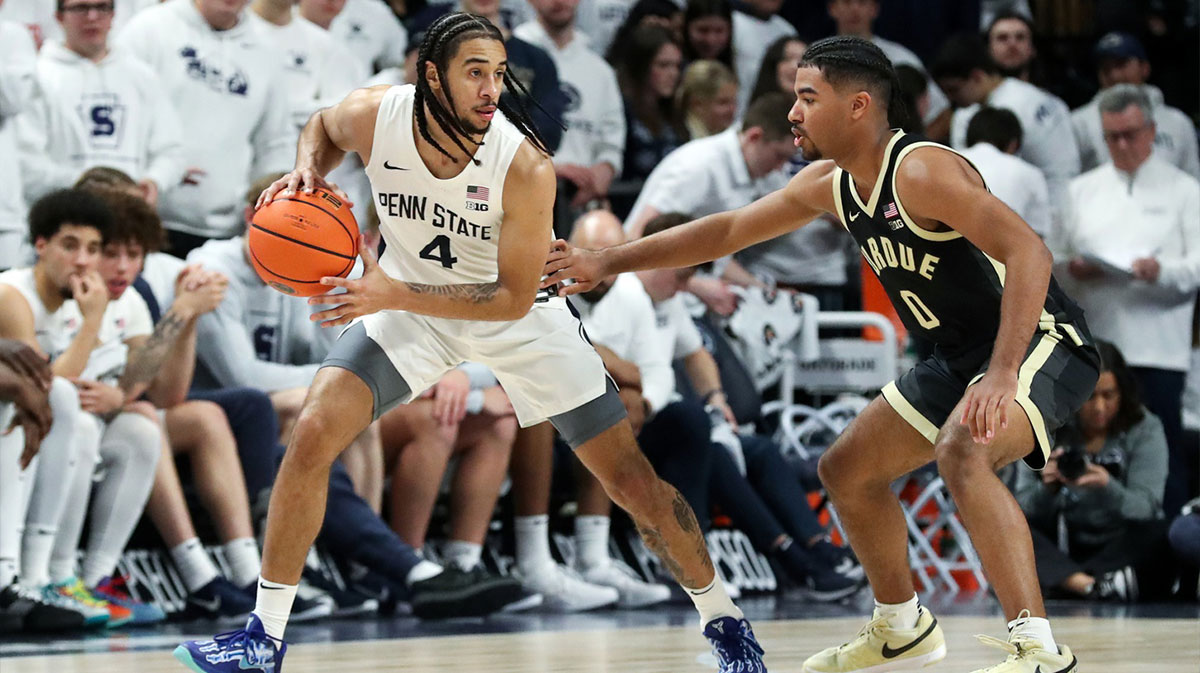 Dec 5, 2024; University Park, Pennsylvania, USA; Penn State Nittany Lions guard Freddie Dilione V (4) holds the ball as Purdue Boilermakers guard CJ Cox (0) defends during the second half at Bryce Jordan Center. Penn State defeated Purdue 81-70.