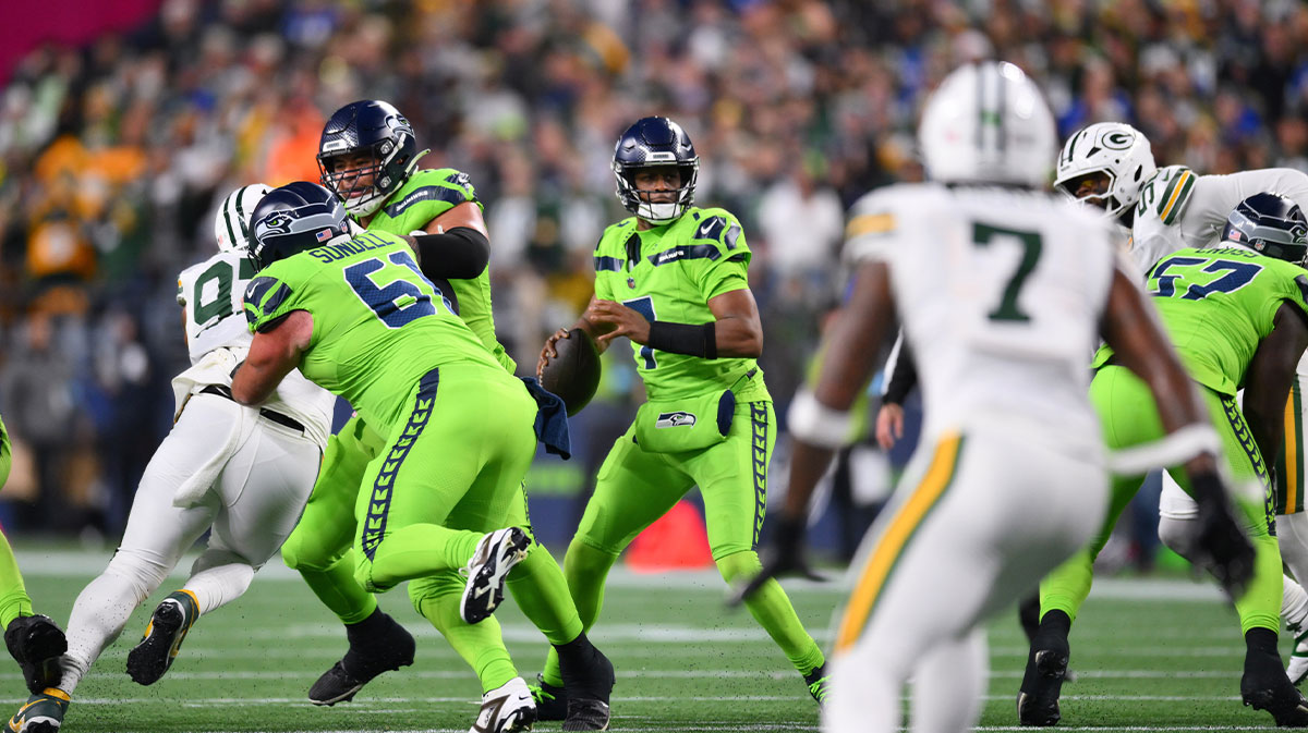 Dec 15, 2024; Seattle, Washington, USA; Seattle Seahawks quarterback Geno Smith (7) looks to pass the ball against the Green Bay Packers during the first half at Lumen Field.