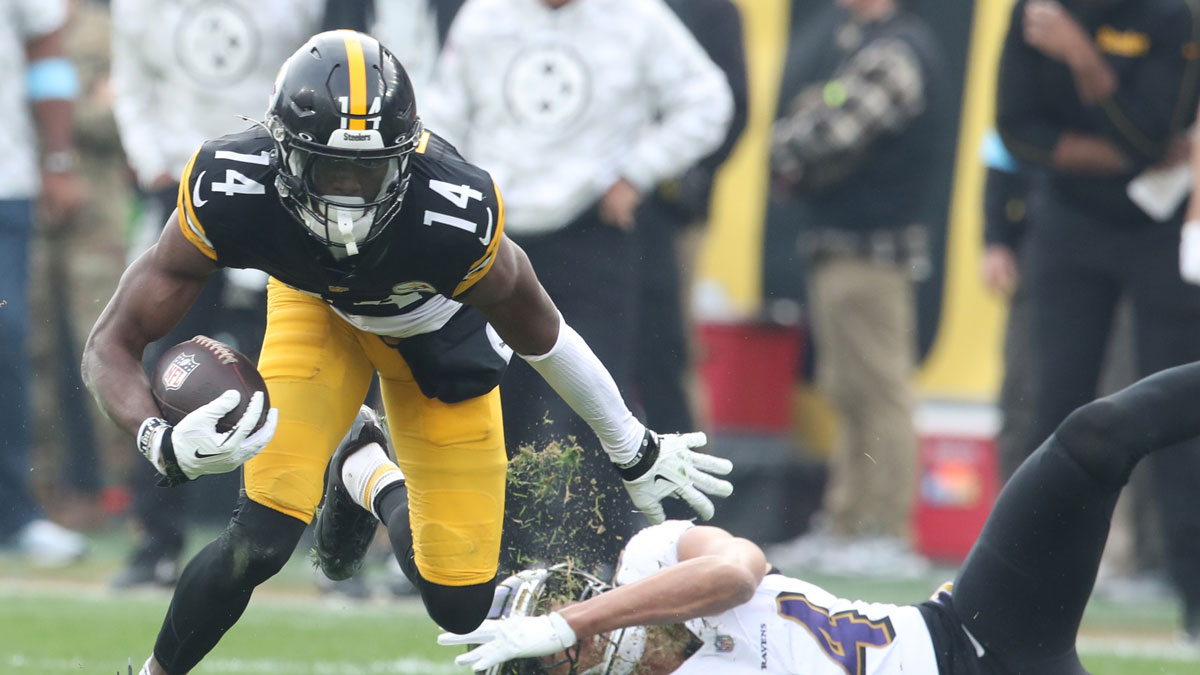 Nov 17, 2024; Pittsburgh, Pennsylvania, USA; Pittsburgh Steelers wide receiver George Pickens (14) runs after a catch against Baltimore Ravens safety Kyle Hamilton (right) during the second quarter at Acrisure Stadium.