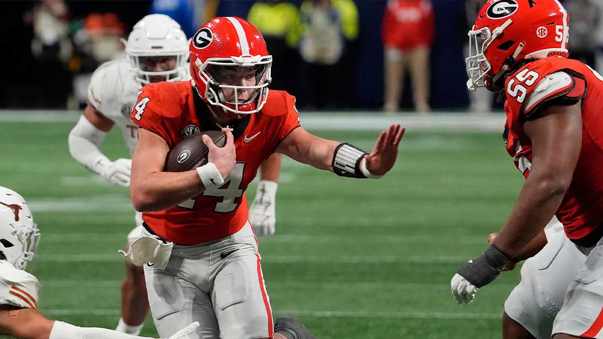 Georgia quarterback Gunner Stockton (14) runs the ball during the second half of the SEC championship game against Texas in Atlanta, on Saturday, Dec. 7, 2024.
