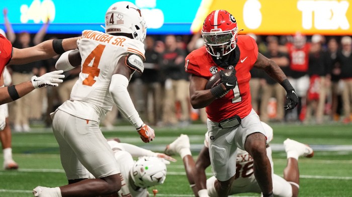 Georgia Bulldogs running back Trevor Etienne (1) rushes for a touchdown against the Texas Longhorns during the second half in the 2024 SEC Championship game at Mercedes-Benz Stadium.
