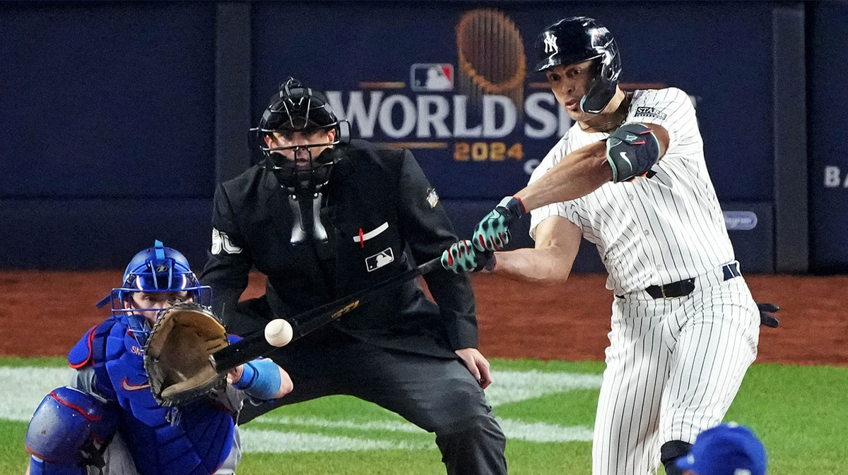 New York Yankees designated hitter Giancarlo Stanton (27) hits an RBI sacrifice fly during the sixth inning against the Los Angeles Dodgers in game four of the 2024 MLB World Series at Yankee Stadium.