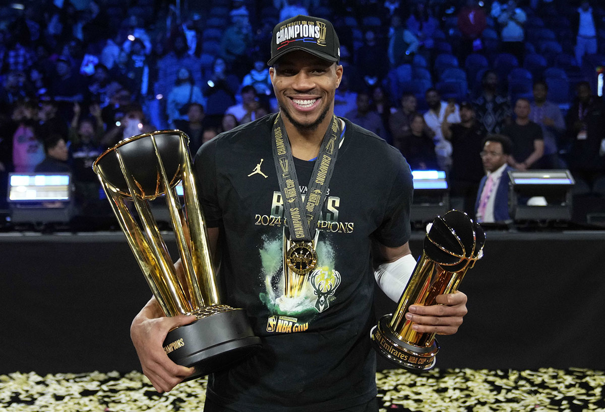 Milwaukee Bucks forward Giannis Antetokounmpo (34) celebrates with the most valuable player and championship trophies after winning the Emirates NBA Cup championship game against the Oklahoma City Thunder at T-Mobile Arena.