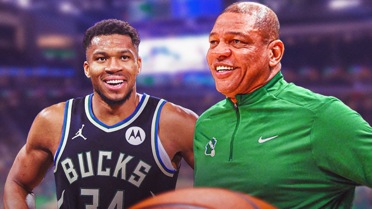 Giannis and Doc Rivers smiling at each other.